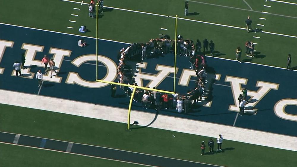 Evacuated students gathered in a prayer circle at Apalachee High School in Barrow County after reports of a shooting.