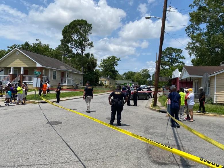 Neighbors on Gwinnett street congregate and some yell at police after Savannah Police Officer Ernest Ferguson shot Saudi Arai Lee on June 24, 2022.  Credit: Jake Shore/The Current GA