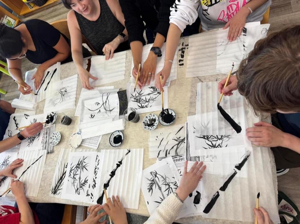 Student take a Calligraphy class at Maomi Bookstore