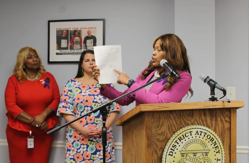 District Attorney Anita Howard points to a petition filed by Cotina Fuller on April 18, 2024 for a family violence protective order against her husband Wayne Fuller, during a press conference August 19. Wayne killed his wife and died by suicide August 16. Jesse Fraga 