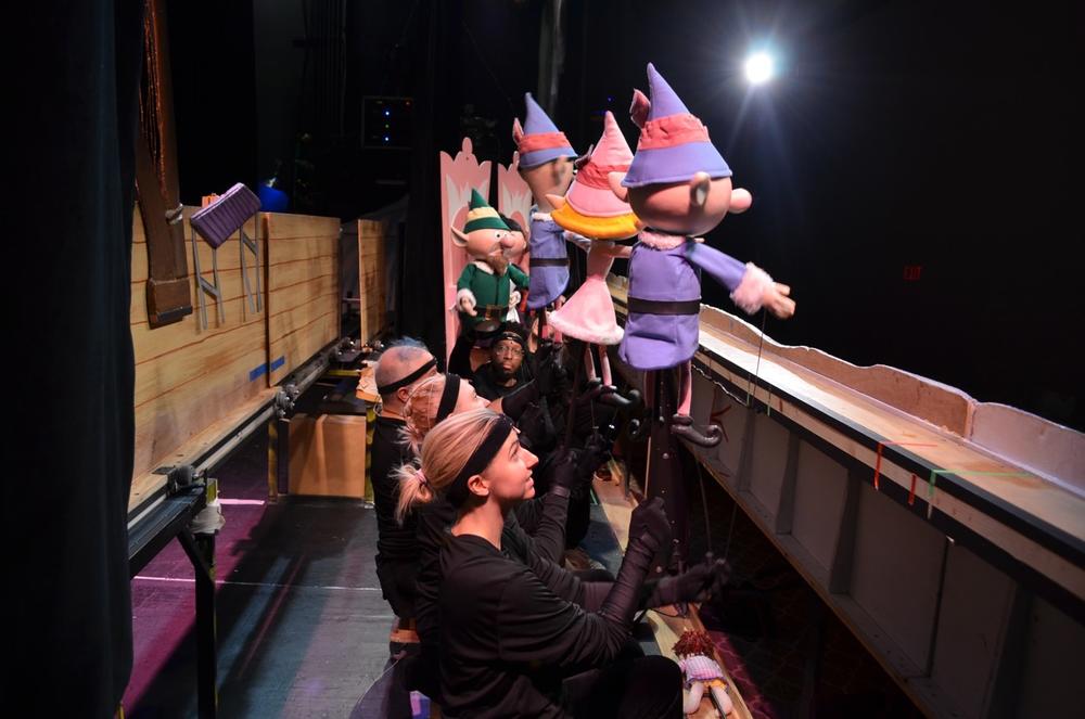 Puppeteers operate Santa's elves during a production of "Rudolph the Red-Nosed Reindeer" at the Center for Puppetry Arts in Atlanta.