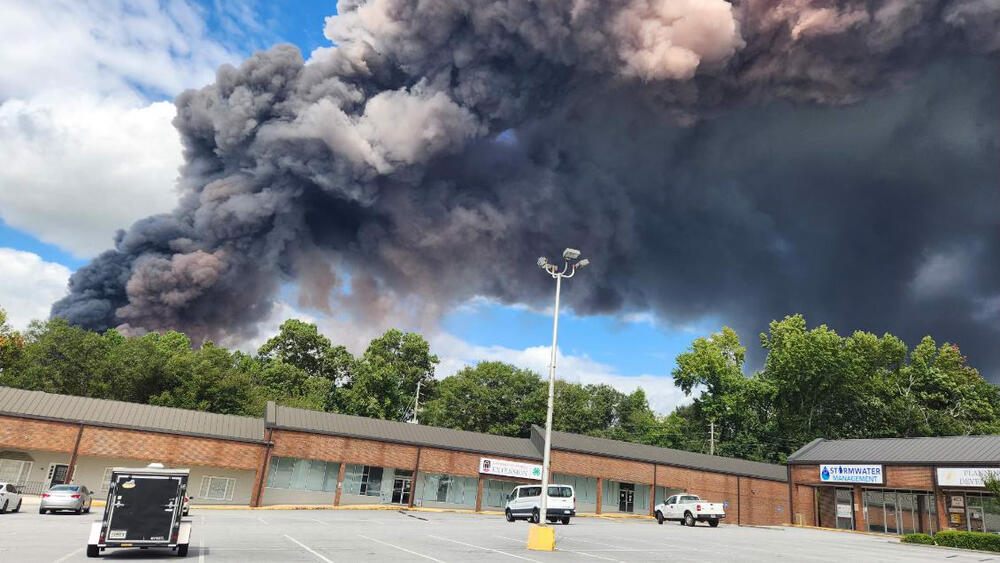 Black smoke billows into the sky above a Conyers shopping plaza as the BioLab chemical fire burns on September 29, 2024.
