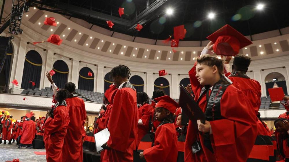 R.I.S.E graduates throw their caps in the air at the R.I.S.E graduation on Thursday, Dec. 19, 2024, at the Macon City Auditorium in Macon, Georgia. Macon Judicial Circuit District Attorney Anita Howard began the Restoring Inspiration by Success in Education initiative in 2022 to support Macon-Bibb County youth impacted by adverse childhood experiences. The number of graduates, or students that completed the program, nearly doubled since 2023. Katie Tucker/The Telegraph