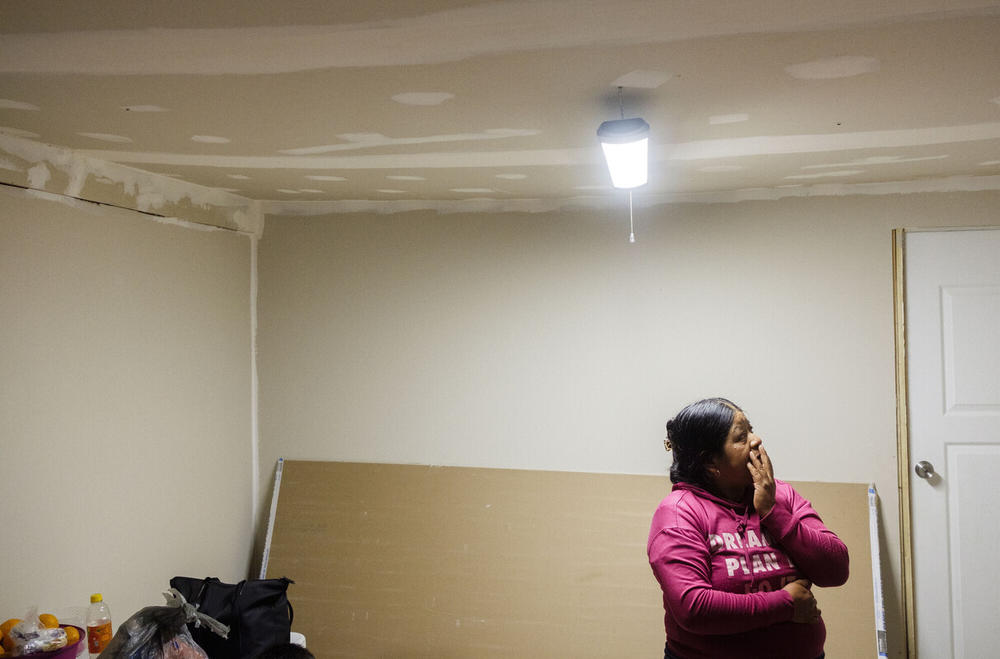 Ana Garcia, a farm worker who lives in South Gerogia, stands in her dining room, newly sheet rocked by her husband in the days after Hurricane Helene. Many farm workers live in trailers or housing that's not fit to weather natural disasters, but because of their legal status, they cannot access help. 