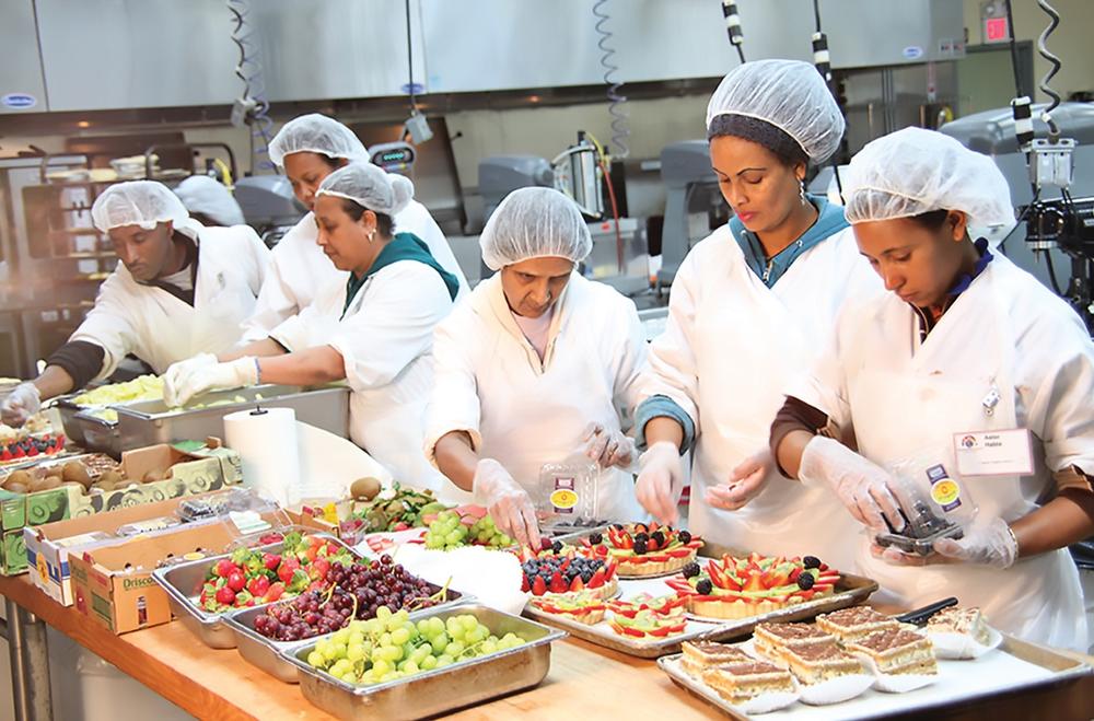 Employees work together to prepare desserts, pastries, and grab-and-go food sold at YDFM. (Provided by Your DeKalb Farmers Market)