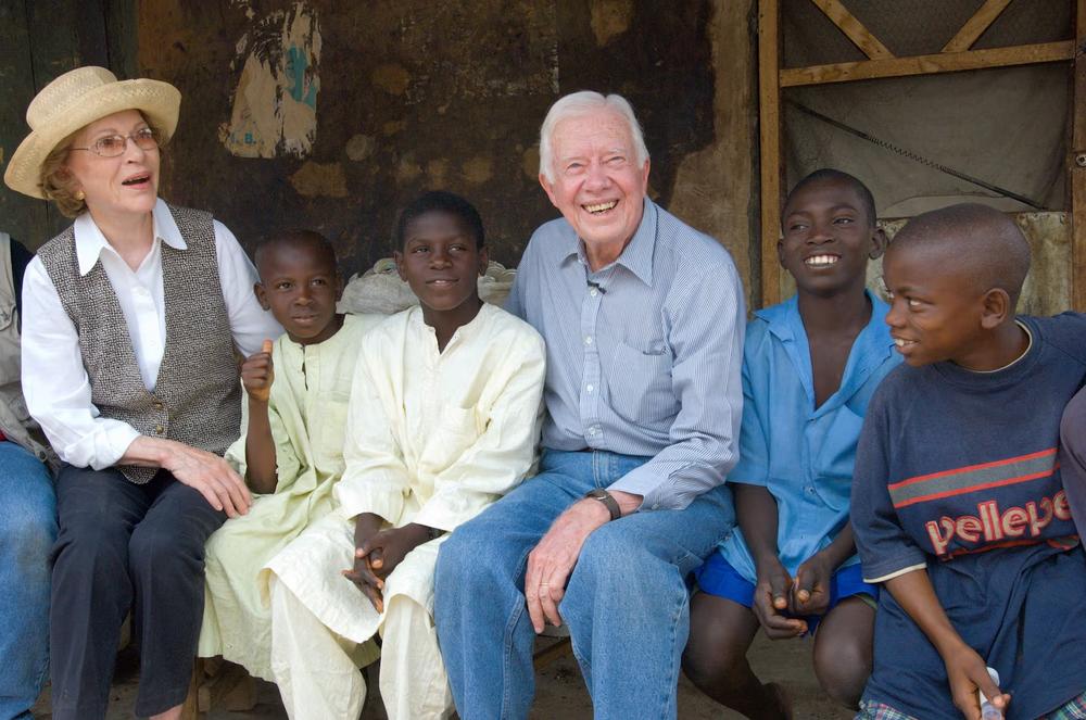 Former President Jimmy Carter and his wife, Rosalynn Carter, meet with boys in Nigeria impacted by schistosomiasis disease in 2007.  (The Carter Center) 