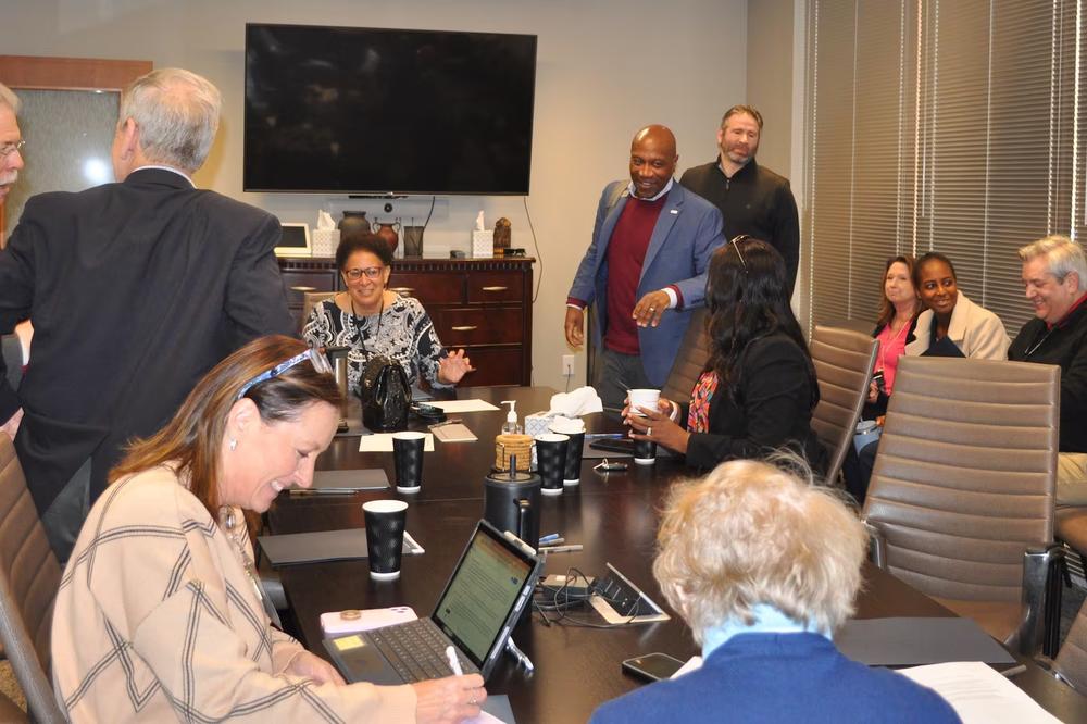 Gwinnett Board of Health members and Gwinnett, Newton, and Rockdale Public Health Department employees speak with each other after the board's meeting in Lawrenceville, Georgia, on Monday. (Allen Siegler / Healthbeat) 