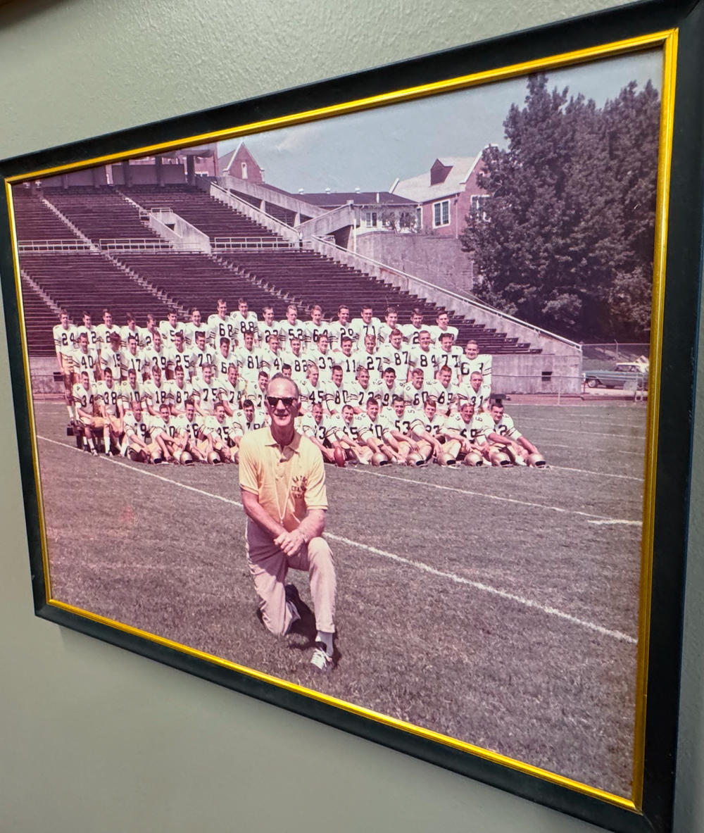 Bobby Dodd poses in front of the Georgia Tech Yellow Jackets