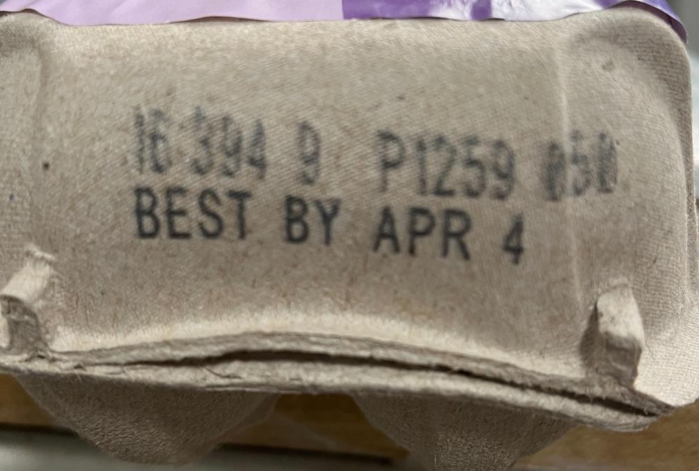 Close up of the "best by" date on a carton of eggs