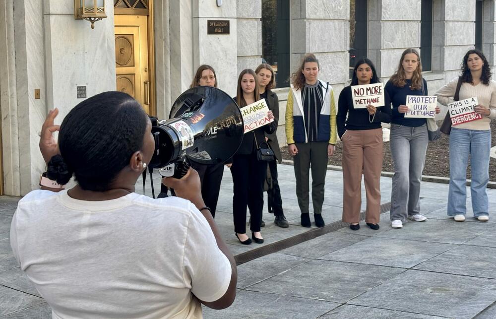 Sierra Club of Georgia community activist Keyanna Jones Moore leads a group of demonstrators outside Tuesday’s Georgia Public Service Commission meeting about Georgia Power’s controversial energy roadmap. Stanley Dunlap/Georgia Recorder.