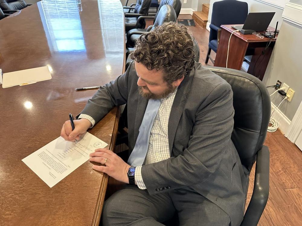 UDA Executive Director Alex Morrison signs off on the sale of seven acres in the 800 block of Riverside Drive to Mercer University to build a new medical school. More than 40 years ago, leaders proposed riverfront development then dubbed “Desoto’s Landing.” Credit: Liz Fabian