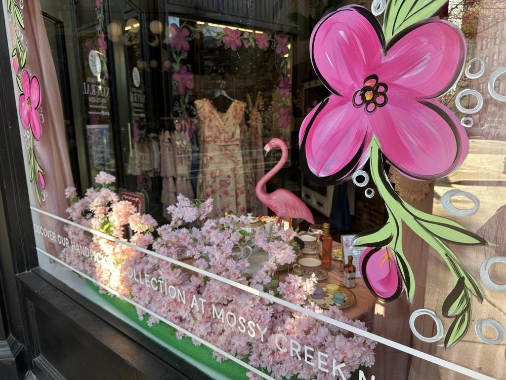 Mossy Creek Natural showcases pink dresses and cherry blossoms in its storefront on Cherry Street.