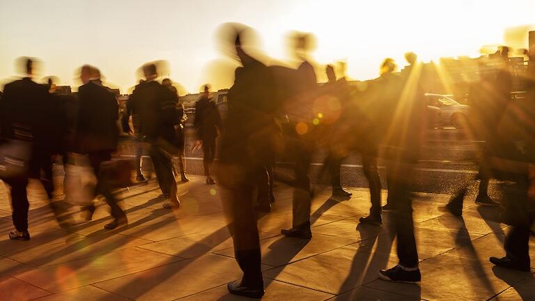 A blurry picture of people walking outside.