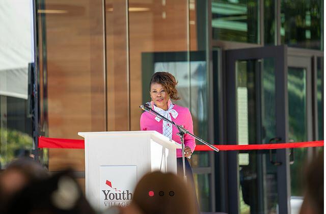 Tanya Anderson stands at a podium on ribbon cutting day for the Youth Villages expansion in Douglasville, Ga. 