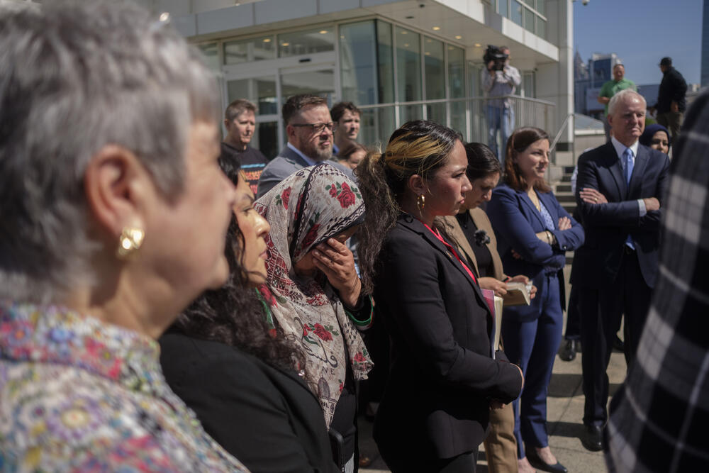 Jawahir Sharwany (center) holds her face in her hand during a press conference following a federal court hearing on April 17, 2025. Atlanta immigration attorney Charles Kuck (far right) argued on behalf of some 133 international college students who for now have no way to continue their studies.
