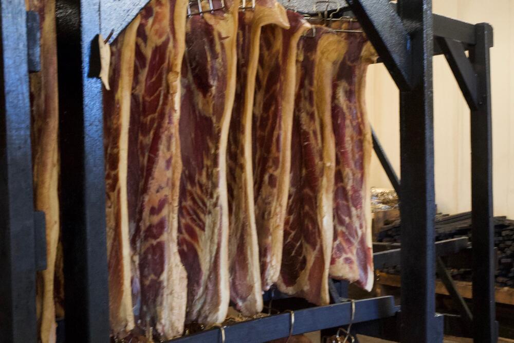 Meat hanging in a smokehouse at Benton's Smoky Mountain Country Hams