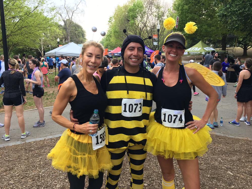 Participating runners wear bee-themed costumes for Atlanta Dogwood Festival's Mimosa 5K