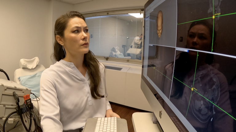 A doctor looking at scans.