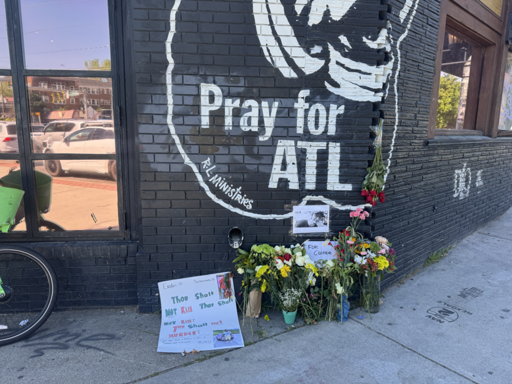 Mourners left flowers at the site of a deadly crash in Little Five Points. Credit: Sarah Kallis/GPB News