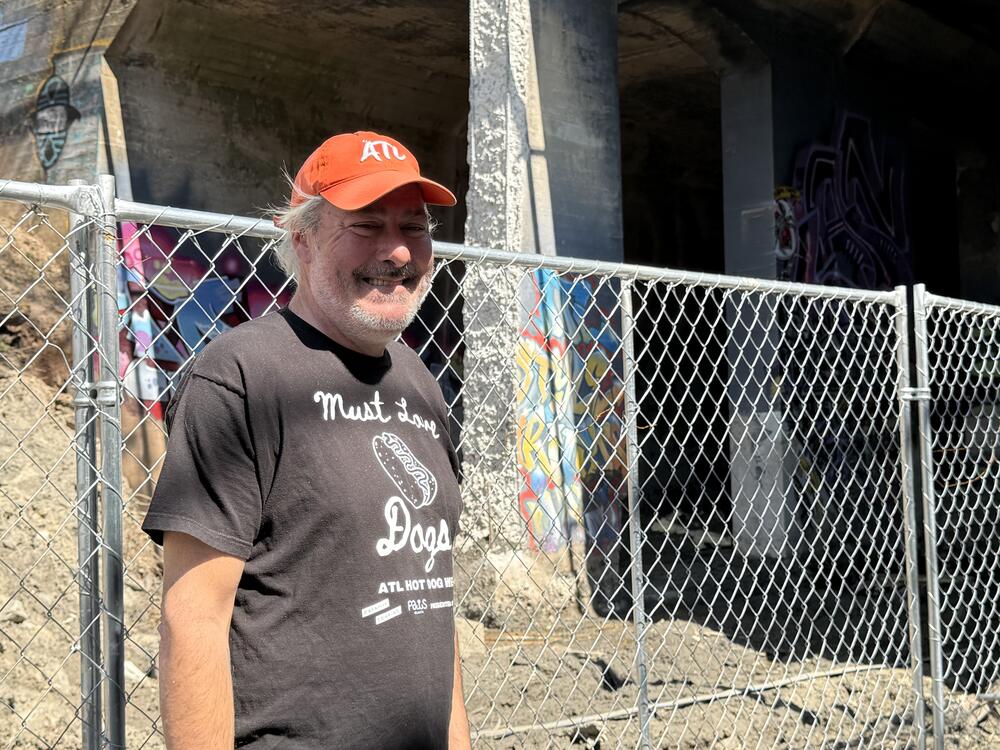 Adair Park resident Matthew Garbett stands on the Beltline in front of two light rail tunnels next to the path.