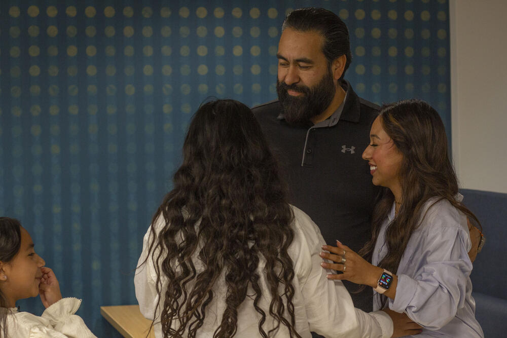 Jose Arias-Tovar embraces 19-year-old Ximena and her younger sisters in Atlanta on May 27, 2025.