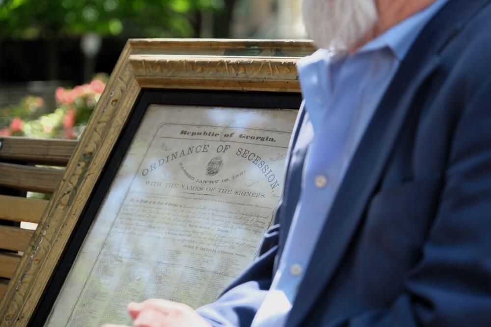 Edwin from Macon sits next to an original copy of Georgia's 1861 ordinance of secession, which he brought to the taping for an appraisal, where it was valued between $30,000 and $50,000 at auction.