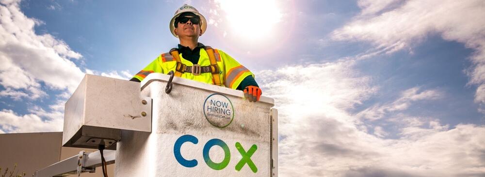 A lineman is seen in a Cox Communications promo image