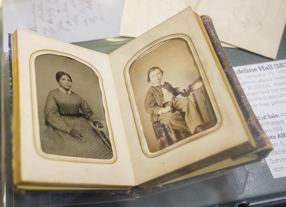 Thsi photo album with a photo of then enslaved nanny Adeline Hall, left, and one of the children she had been charged with raising, right, had been in storage before a Geogia Humanities grant. 