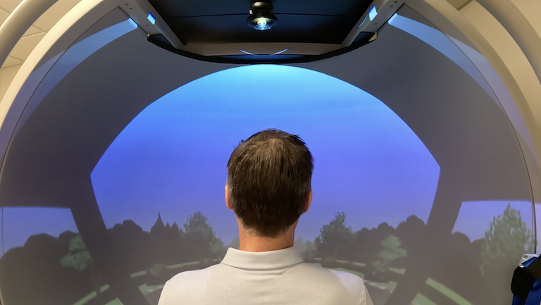 A man looking into a projected image.
