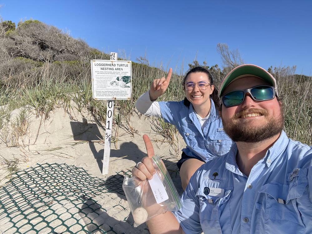 Jekyll Island Authority wildlife conservation technicians Bailey Yarborough and Will Hicks pose after finding Georgia's first sea turtle nest of the 2025 nesting season on May 1 along Glory Beach.