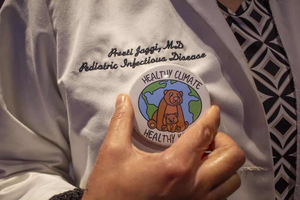 Dr. Preeti Jaggi adjusts a pin made by her child that reads "Healthy Climate, Healthy Kids" at the CleanMed conference in Atlanta on May 6.