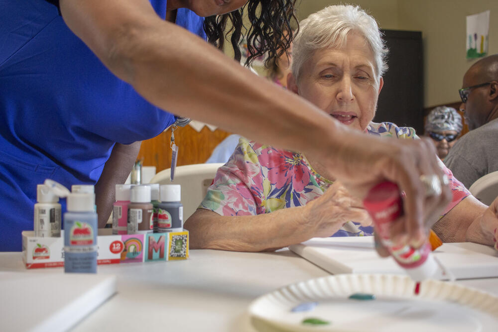 Susan Harrison gets ready to paint at Homeplace Adult Day Center in Wrens, Ga. Adult day centers are designed to give elderly and disabled adults and their caregivers an alternative to out-of-home placement.