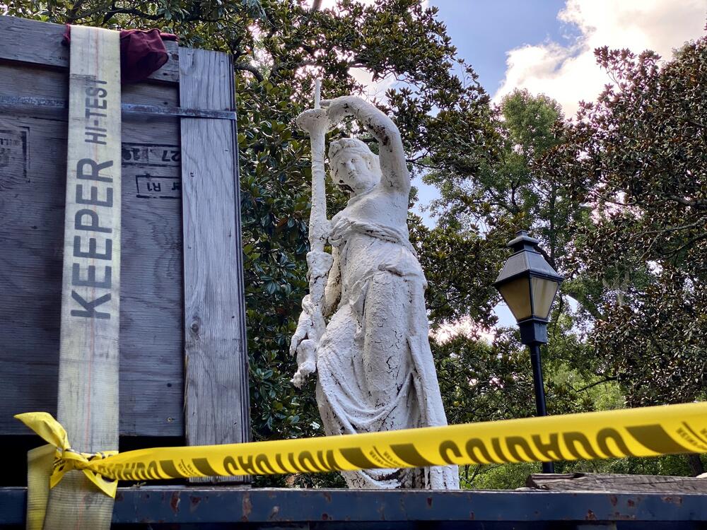 The fountain's crowning statue sits on a flatbed truck, which will transport it to a repair shop in Alabama.
