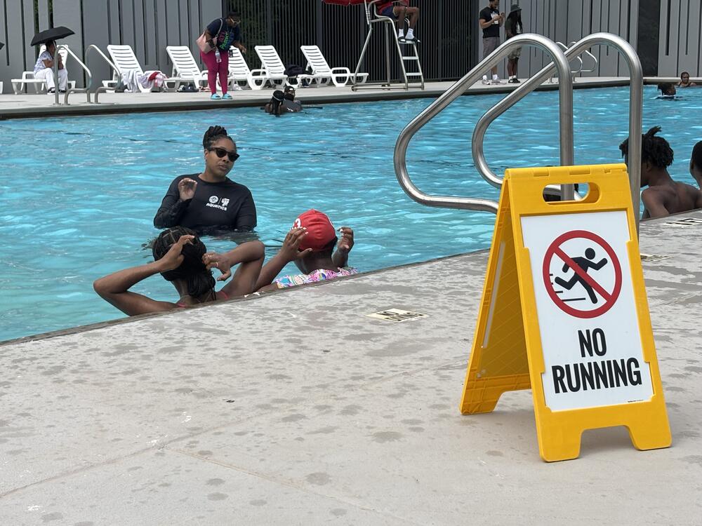 A swim instructor speaks to children in the Thomasville pool in Atlanta