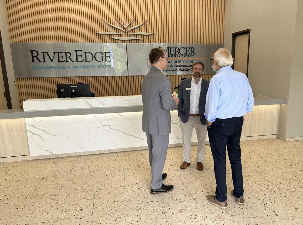 Parrish Construction Group’s Charlie Griffis, center, speaks with architect Kamal Azar, right, and another visitor Thursday at the new River Edge Crisis Services and Diagnostic Center and Mercer University School of Medicine’s Center for IDD Care. (Liz Fabian/The Macon Newsroom)