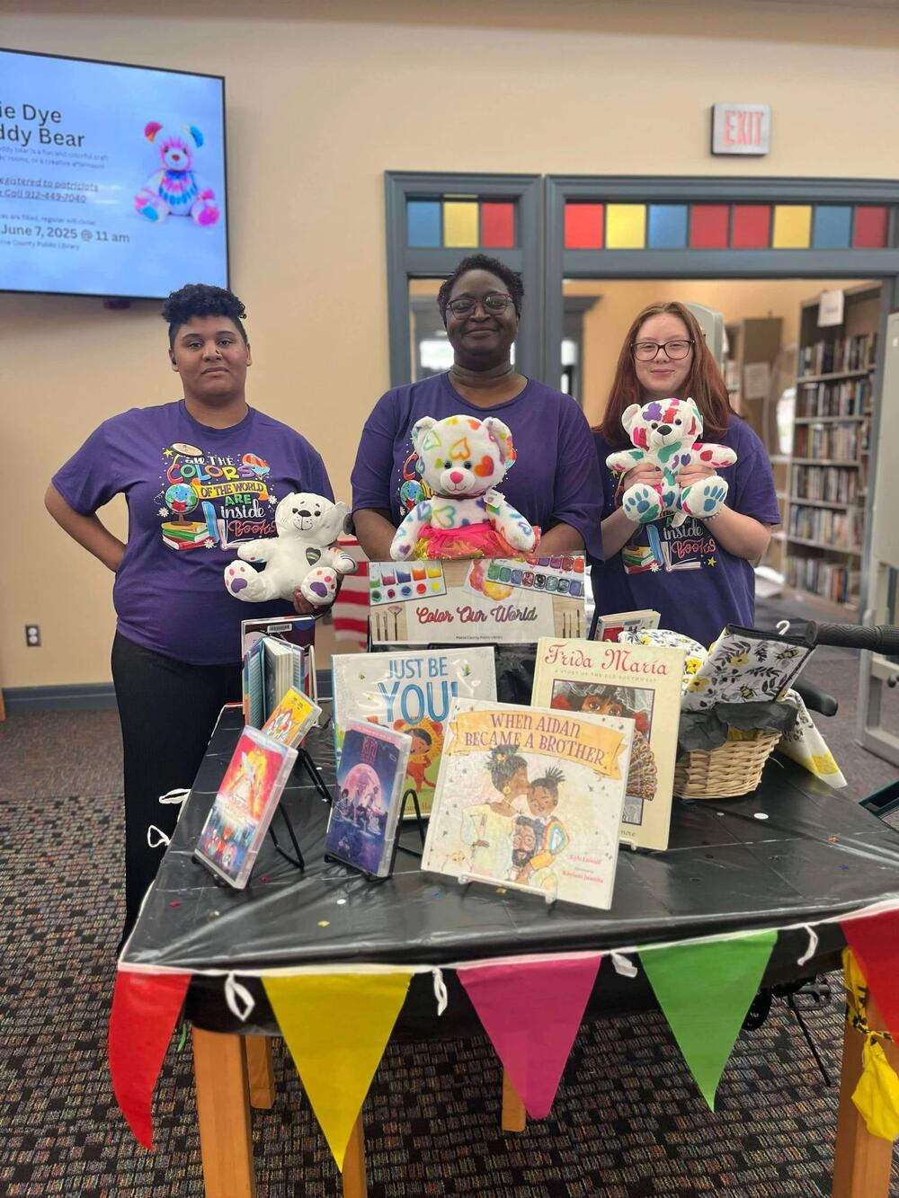 Lavonnia Moore (center) stands with the book display that she says led to her firing.