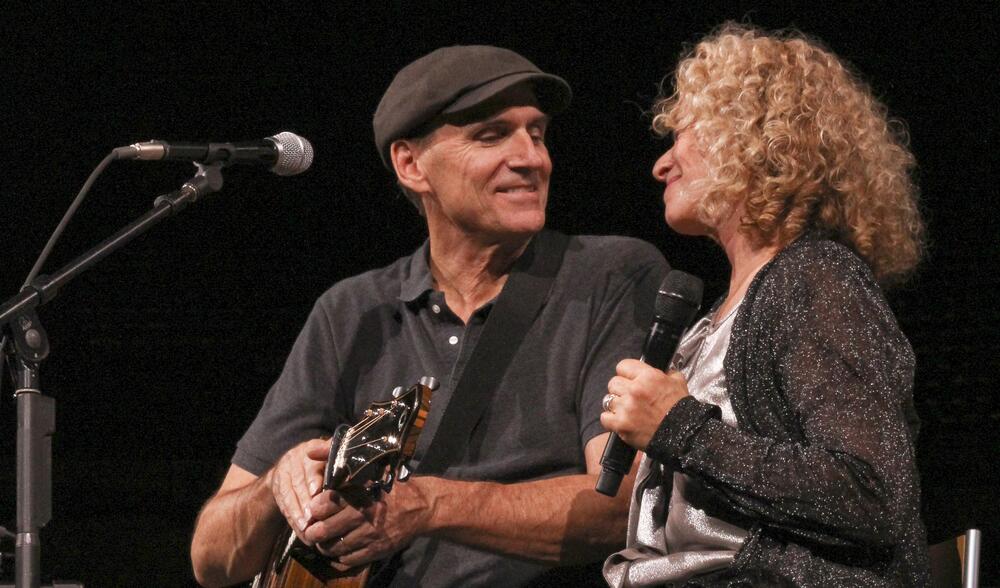 James Taylor and Carole King on stage.
