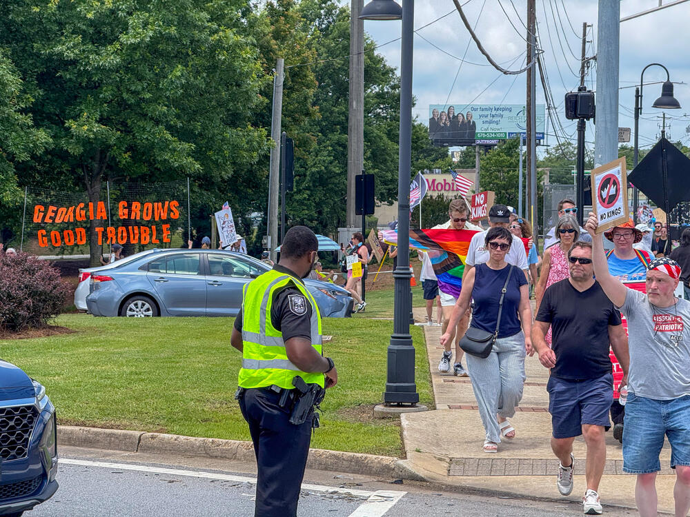 Protesters marched along LaVista Road in Tucker as part of the nationwide “No Kings” demonstrations. DeKalb County police as well as Georgia state patrol were on site to assist with traffic control.