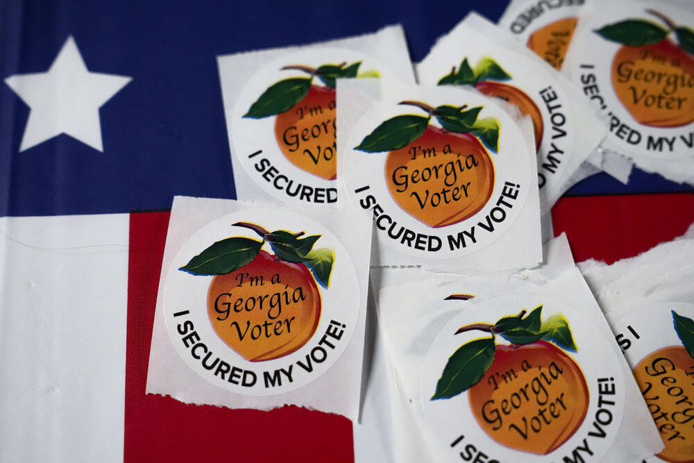 FILE - Stickers lay on a table inside a polling place, Tuesday, Nov. 5, 2024, in Atlanta. (AP Photo/Brynn Anderson, File)