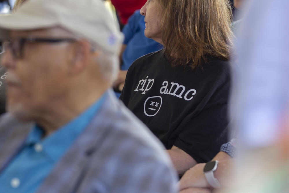 A former health care provider at Wellstar Atlanta Medical Center, Cindy Flynn, wears a t-shirt that reads "R.I.P AMC" on the first day of the hospital's demolition on June 30, 2025. The sudden closure of the hospital in 2022 left many staff surprised and angry.