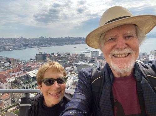 A selfie of George King and his wife on a balcony