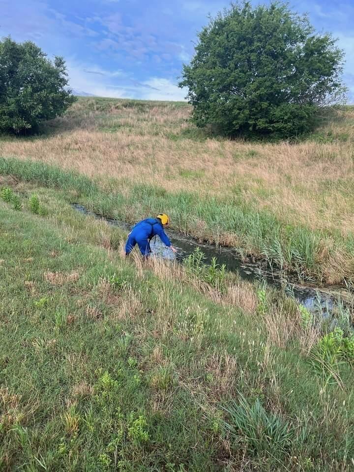 Staff of the Chatham County Mosquito Control checking a ditch for mosquito larvae.