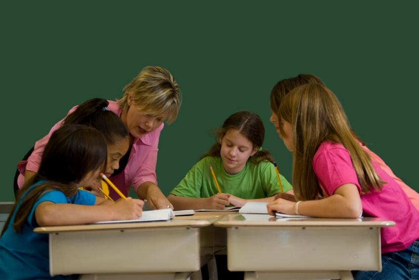 In this undated photo, a teacher works with young students in a classroom.