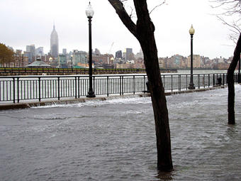 The Hudson River swells and rises over the banks of the Hoboken, NJ. Photo courtesy Charles Sykes/AP