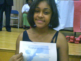 My goddaughter Machaela Goodbee shows off her honor roll certificate. Way to go Machaela!