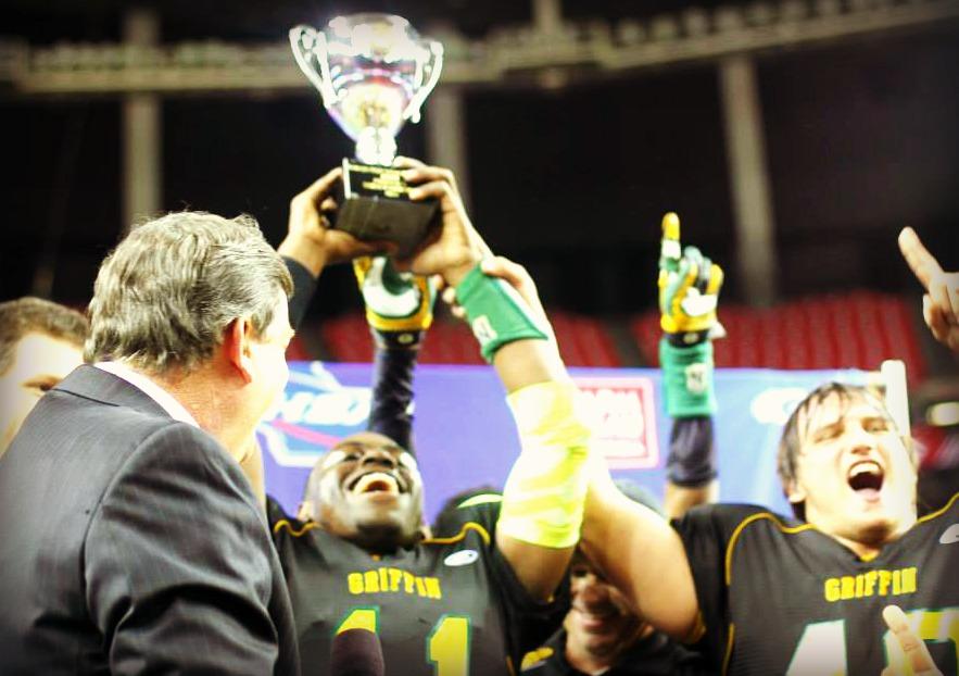 The Griffin Bears hoist the AAAA state championship trophy.