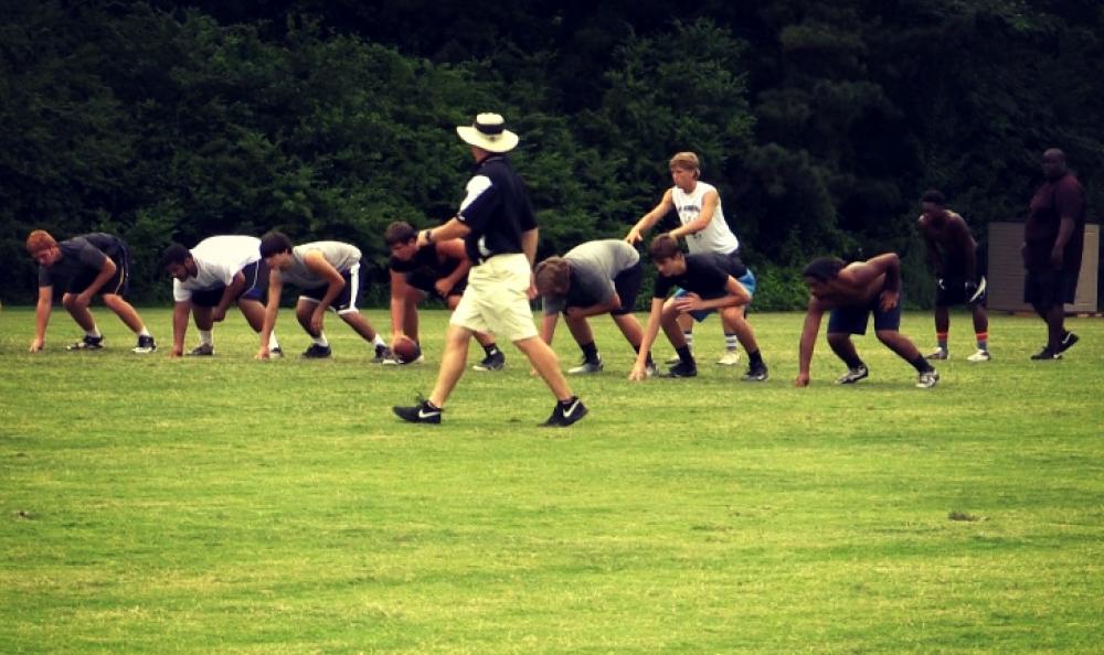 New Carrollton Head Coach Ed Dudley directs the action at a summer practice.