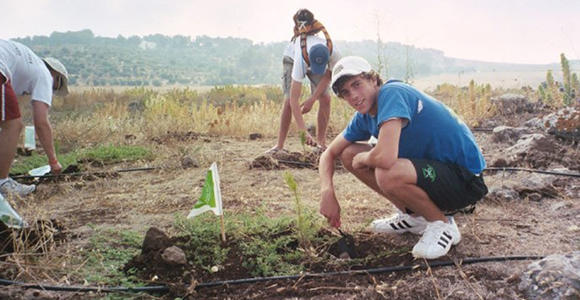 Jeremy Katz plants a tree in Israel in 2005. Photo courtesy Jeremy Katz