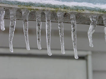 Icicles on the side of the house.