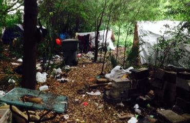 A wooded camp of unhoused people during the 2010s.